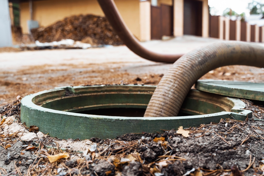 Pipe in the drainage pit. Pumping out sewage from a septic tank